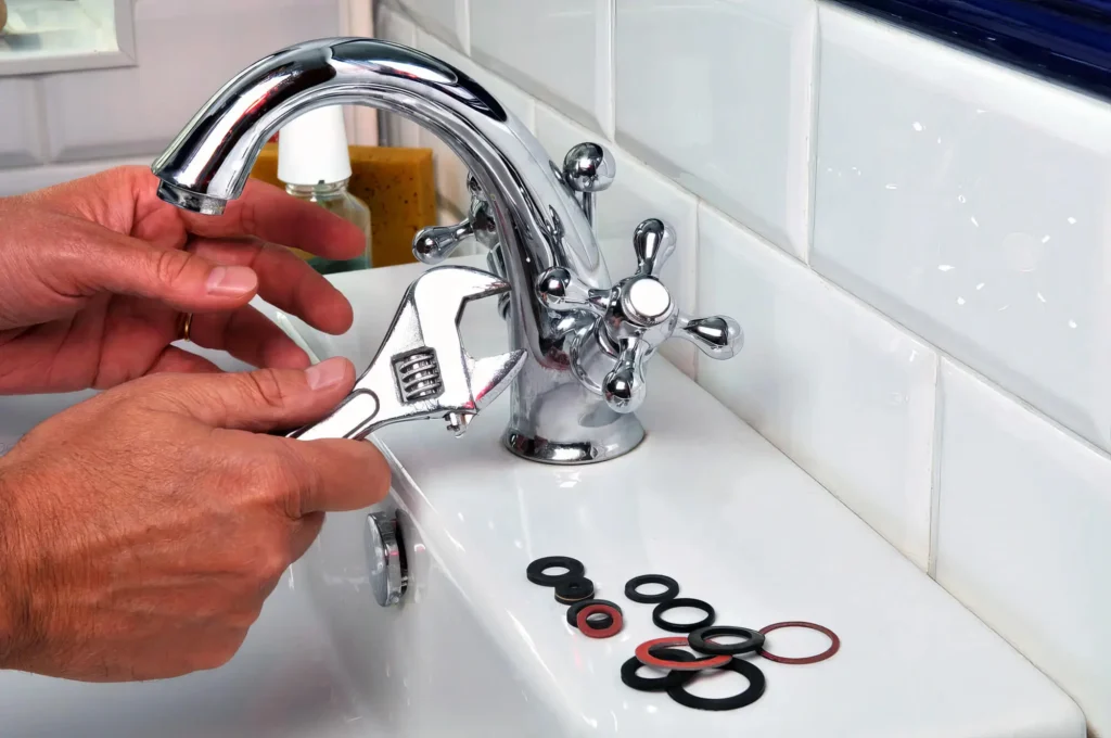 Plumber performing maintenance on a bathroom faucet in Panama City