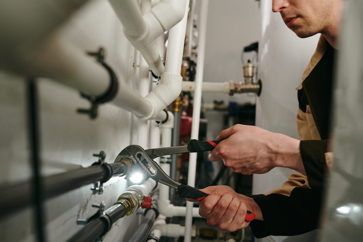 Plumbers maintaining commercial plumbing pipes in Panama City