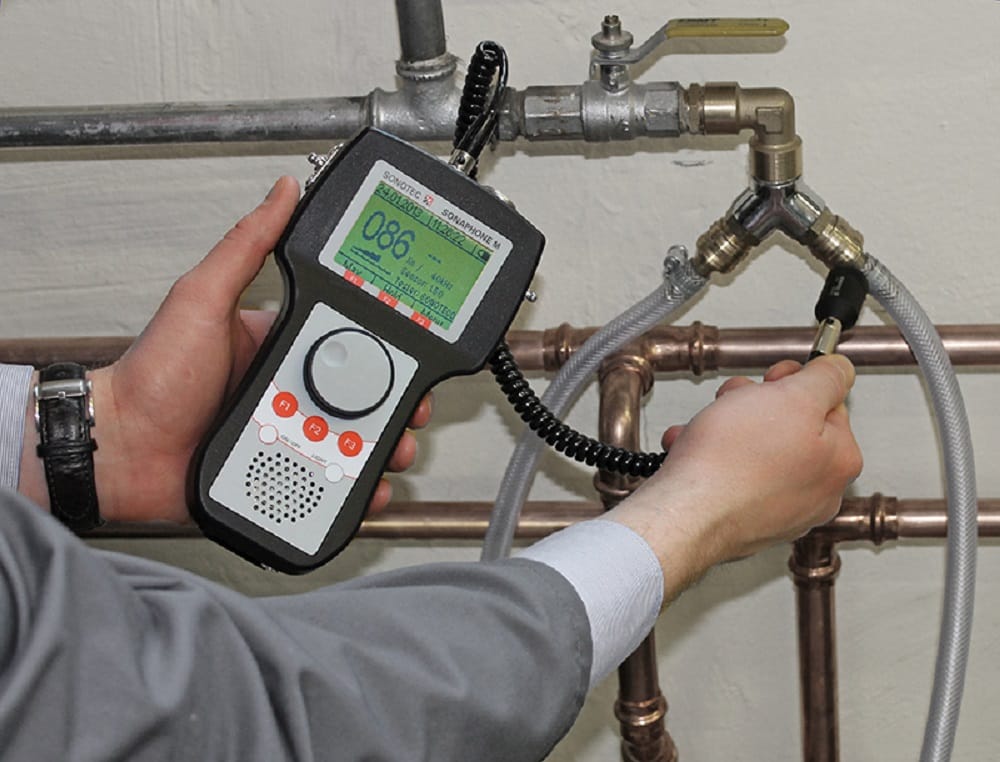 Plumber testing pipes with electronic leak detection equipment in Panama City