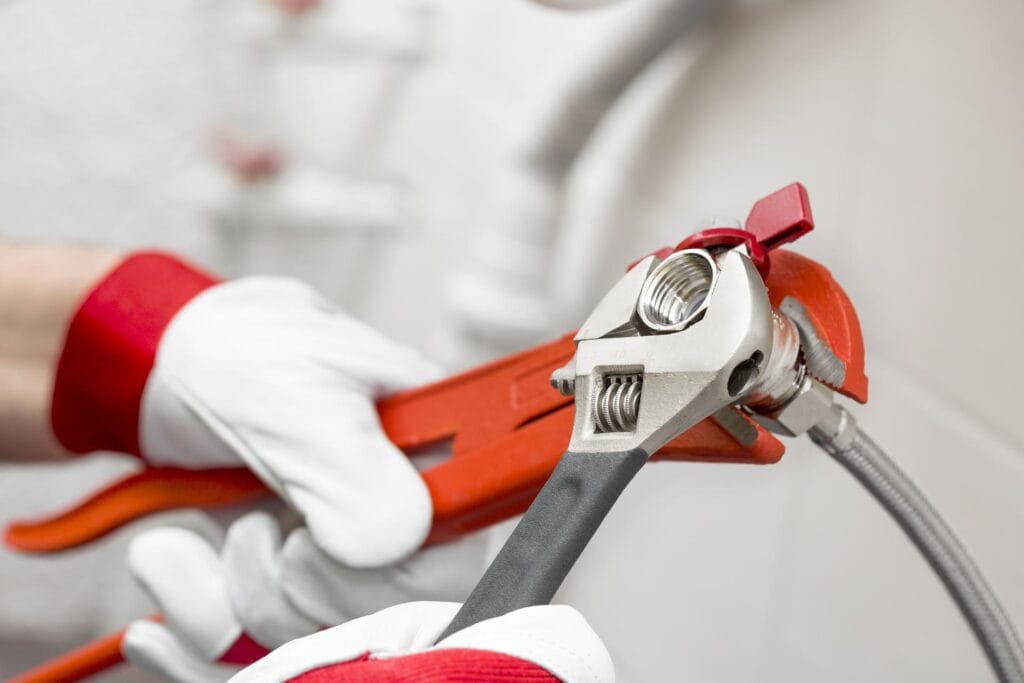 Plumber holding pipe wrenches for an emergency repair in Panama City