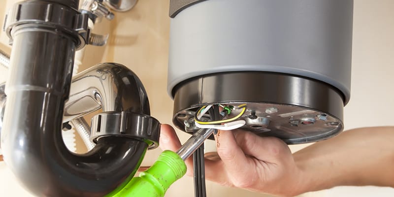 Technician repairing the heating element of a water heater in Panama City