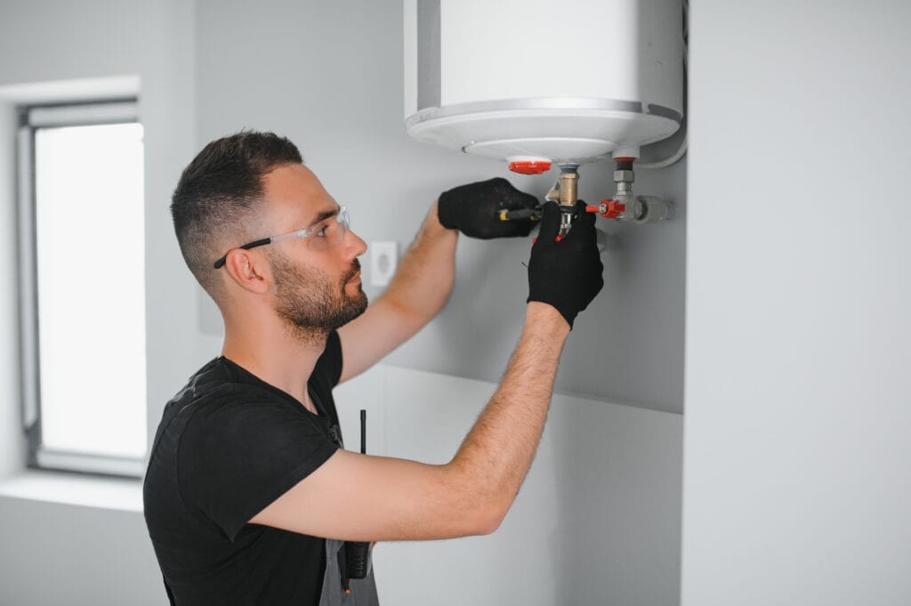 Technician performing water heater maintenance in Panama City