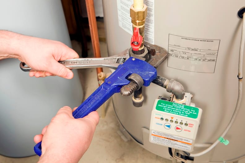 Plumber repairing a water heater valve in Panama City